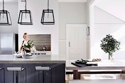 Simple, modern kitchen with island counter & bar stools