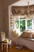 Dramatic window seat in window bay in elegant girl's bedroom of historical house