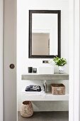 View of modern washstand and framed mirror through open sliding door