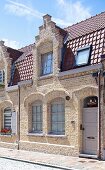 Wilhelmine era house with brick facade and lattice windows in sunshine
