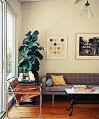 Brown leather Wassily chair and coffee table next to grey, cubic sofa