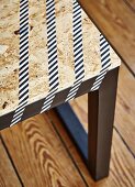 DIY bench with black-painted frame and pale chipboard seat decorated with washi tape