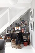 Workspace below staircase; wicker chair at vintage desk and various noteboards on wall