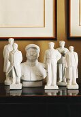 China figurines of Mao Zedong on wooden cabinet