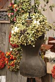 Tailors' dummy with wreath of hops on autumn market