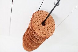 Swedish crispbread threaded on suspended metal rod