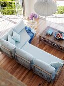 View down onto designer sofa and rustic wooden coffee table