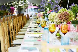 Long dining tables in garden set for birthday party