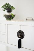 Oriental tassel hanging from black, Oriental-style cabinet handle fitting