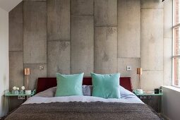 Master bedroom - pale turquoise scatter cushions on French bed against wall with concrete-look vertical tiles
