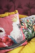 Cushions with colourful bird motifs on sofa