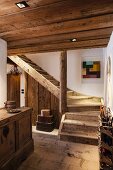 Wooden stairs and hallway furniture in old, restored farmhouse