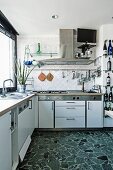 Modern, white, functional kitchen with terrazzo floor
