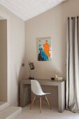 Modern artwork above small workspace with concrete desk and classic chair