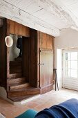 Rustic foyer with integrated wooden staircase