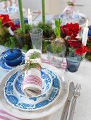 Blue and white place setting with napkin on festively set table