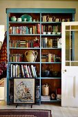 Pale blue shelving against wall of rustic living room