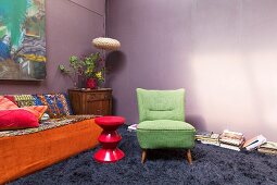 Long-pile carpet and flea-market furnishings in living room with purple walls