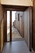 Camber Sands Beach Houses, Rye, United Kingdom. Architect: Walker and Martin, 2014; View out through front door directly onto sandy beach
