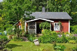 Small wooden house in summery garden