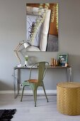 Console table and green retro metal chair against grey-painted wall