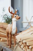 A decorative young deer between planks of wood