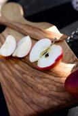 Sliced apple on wooden chopping board