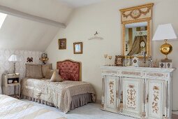 Elegant, antique furnishings and accessories in attic bedroom