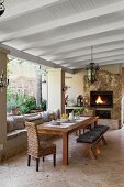 Dining area on roofed patio with open fire