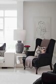 Black wing-back chair in elegant white interior