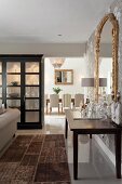 View past Illuminated display case and mini-bar into classic dining room