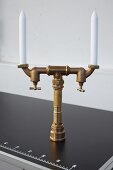 DIY candelabra made from brass pipes and shut-off valves