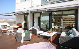 Lounge furniture and dining area on spacious roof terrace with teak floor