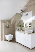 Modern washstand with countertop sink and white base unit in bathroom with sand-coloured wall and floor tiles