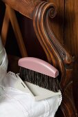 Dustpan and brush on antique chair