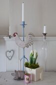 Romantic, country-house Easter arrangement of spring flowers and various candlesticks