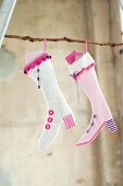 Hand-crafted Christmas stockings filled with gifts and hung from branch