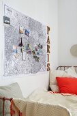 And map of Paris decorated with souvenirs hung above a bed