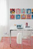 Record covers decorating the wall in front of a desk with a ghost chair