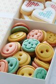 Biscuits shaped like buttons and love-hearts in gift box