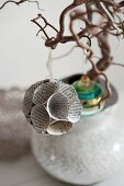 Spherical bauble made from old book pages hanging from tree