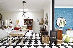Open-plan kitchen with eclectic dining area and chequered floor