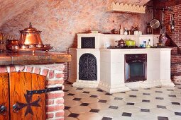 White-tiled, masonry kitchen counter and white-tiled floor with dark accent tiles in Medieval-style kitchen