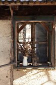 Bouquet of dried flowers on windowsill of rustic wooden window