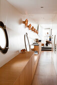 Custom, fitted sideboard in narrow houseboat corridor