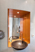 Sink and mirror in wood-clad niche