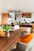 Various upholstered chairs around dining table in open-plan kitchen