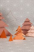 Decorative copper-coloured Christmas trees made from paper, wire and metal foil