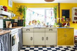 Yellow retro kitchen room with chequered floor