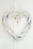 Heart-shaped wreath made of chiffon ribbon with pearl drop beads as wedding decoration